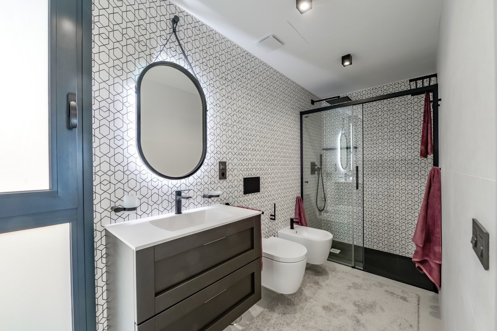 A modern bathroom with patterned tile and sleek fixtures in a 7-bedroom villa in Finestrat - The Estates