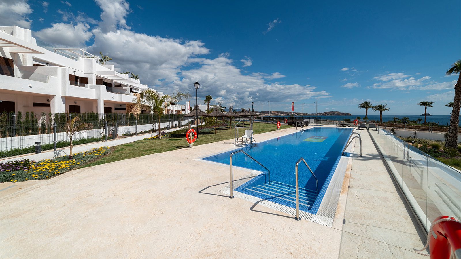 A swimming pool and landscaped garden area of a 2-bedroom bungalow in Pulpí - The Estates