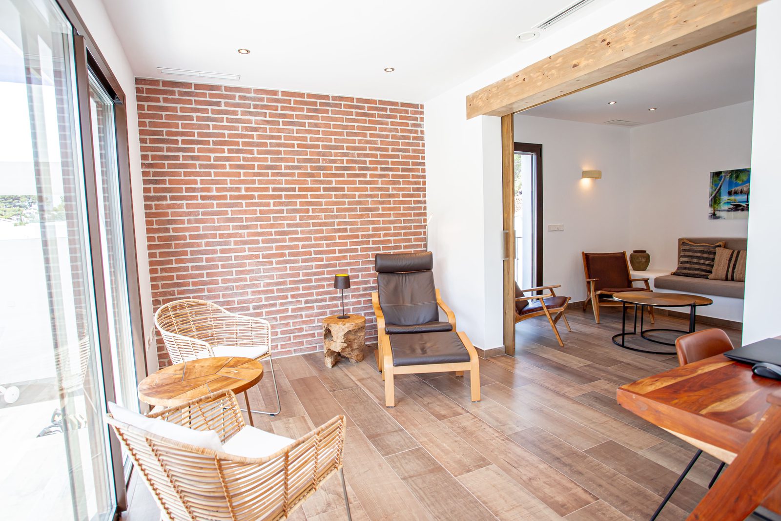 Stylish living room with brick accent wall and comfortable seating in a 3-bedroom villa in Javea - The Estates