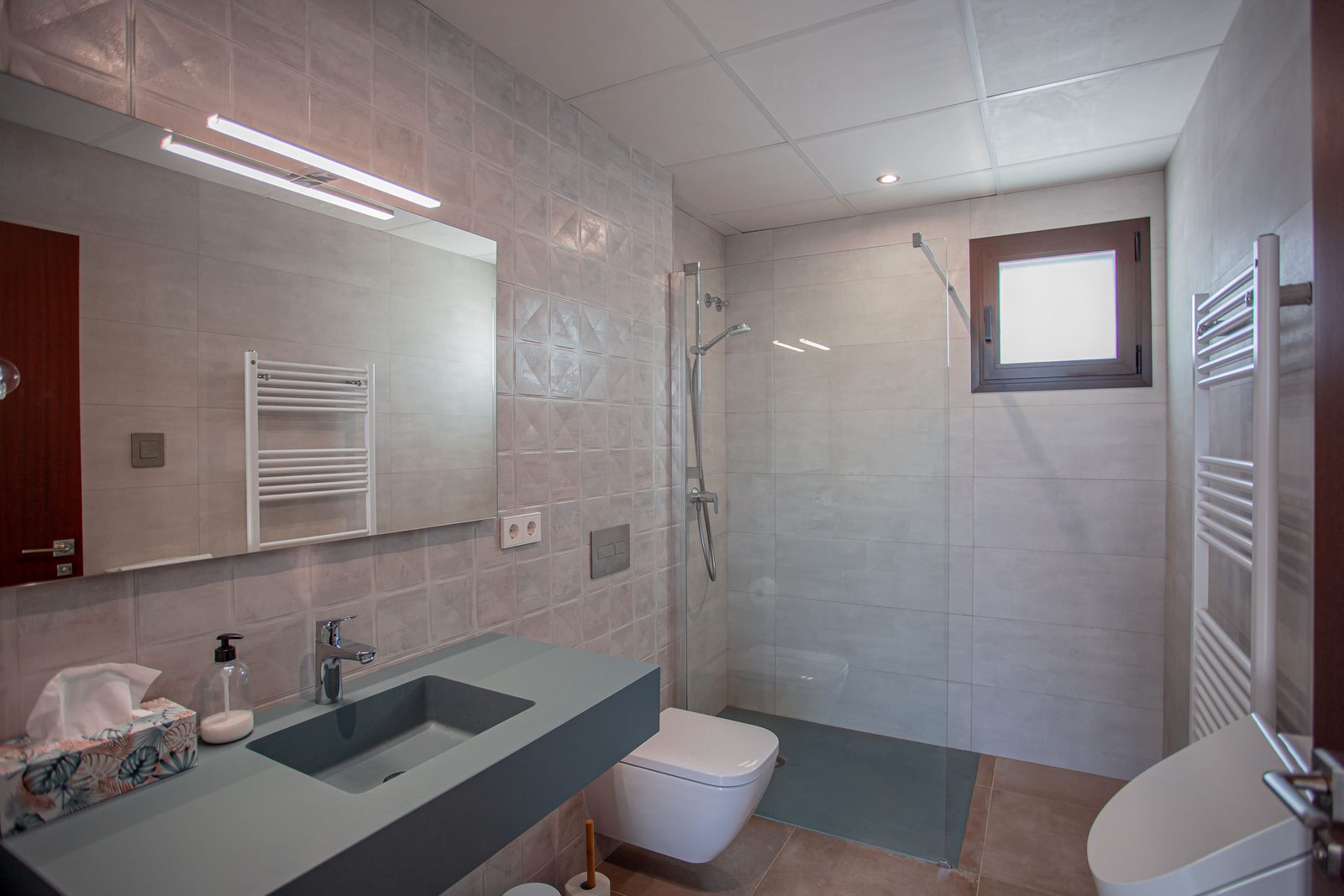 A modern bathroom with a walk-in shower in a 3-bedroom villa in Javea - The Estates