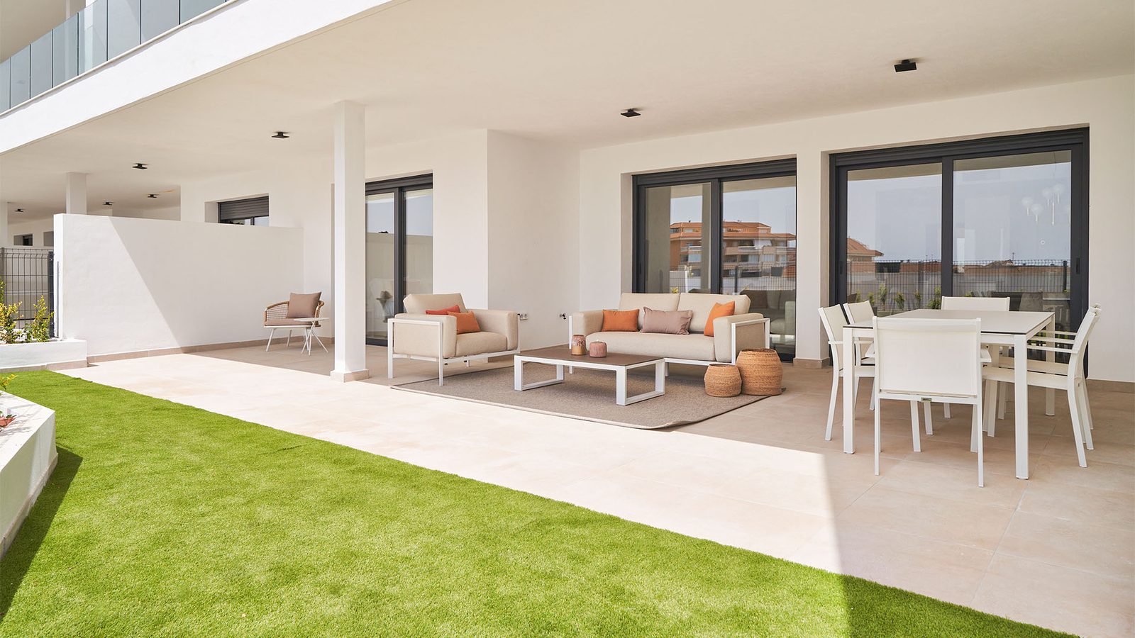 A bright living area with outdoor seating and a view of the sea in a 2-bedroom apartment in Fuengirola - The Estates