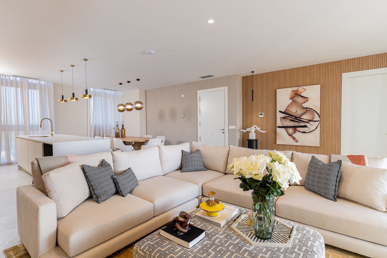 Stylish living room with a comfortable sofa and dining area in a 3-bedroom apartment in Benidorm - The Estates