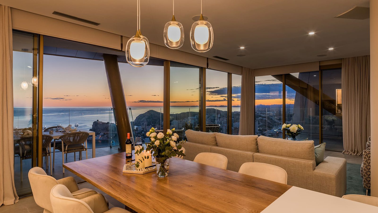 Stylish living and dining area with stunning sea and city views in a 3-bedroom apartment in Benidorm - The Estates