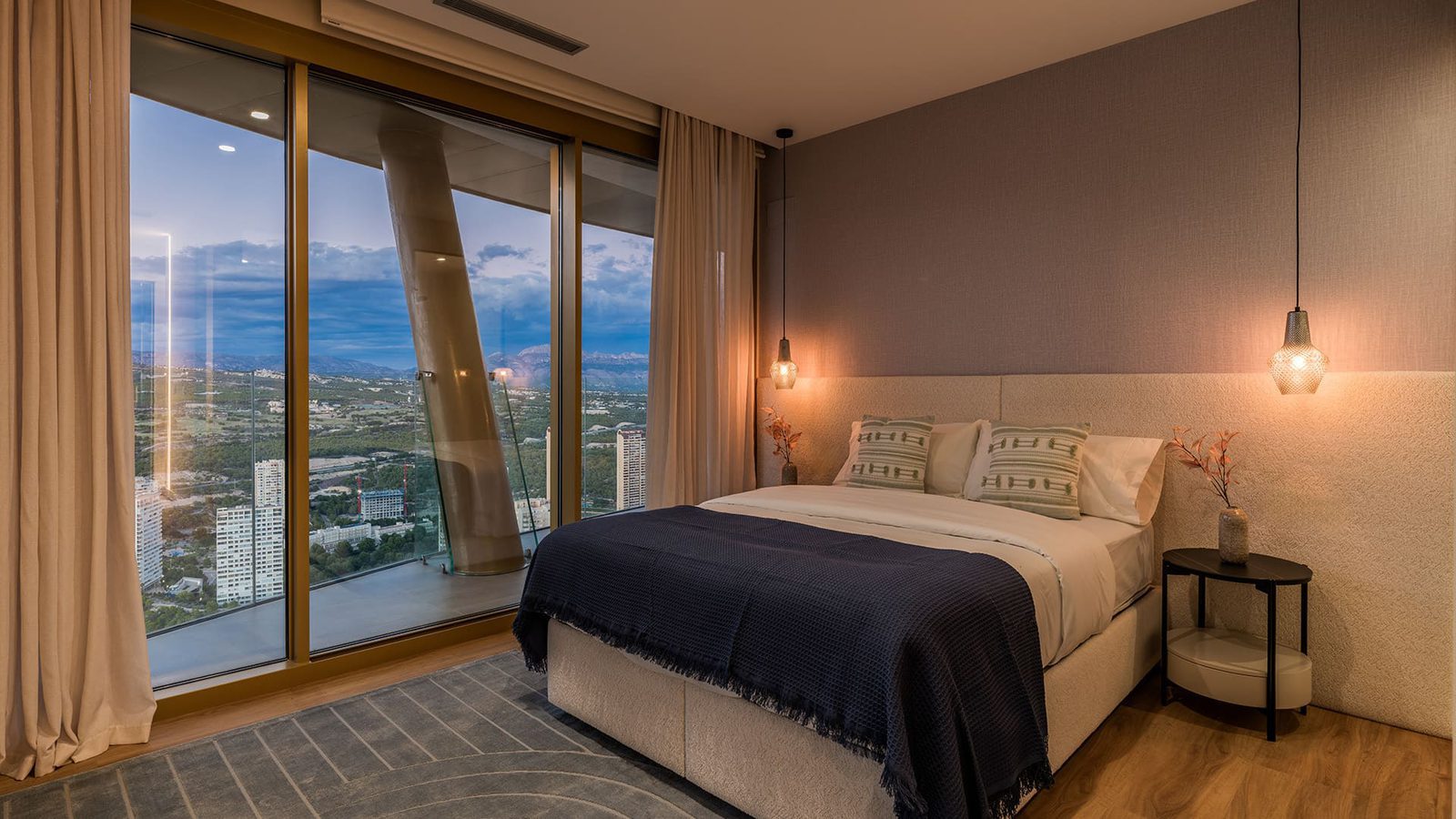 A stylish bedroom with panoramic sea and mountain views in a 3-bedroom apartment in Benidorm - The Estates