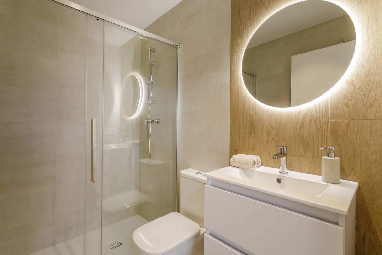 A modern bathroom with a walk-in shower and vanity in a 2-bedroom apartment in Torrevieja - The Estates