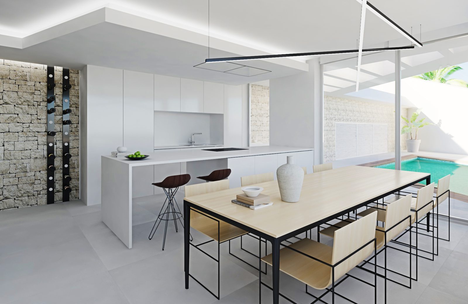 Modern open-plan kitchen and dining area overlooking a private pool of a 3-bedroom apartment in Cal