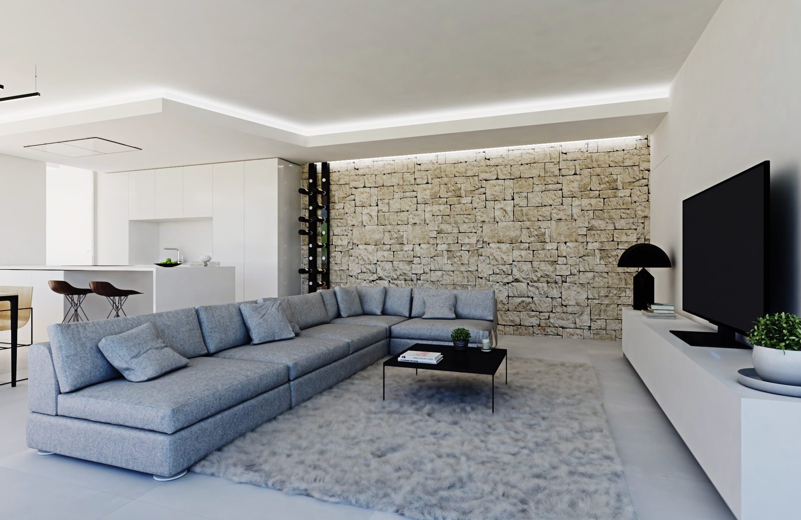 Modern living room with sectional sofa, stone feature wall and open kitchen in a 3-bedroom apartment in Calpe - The Estates