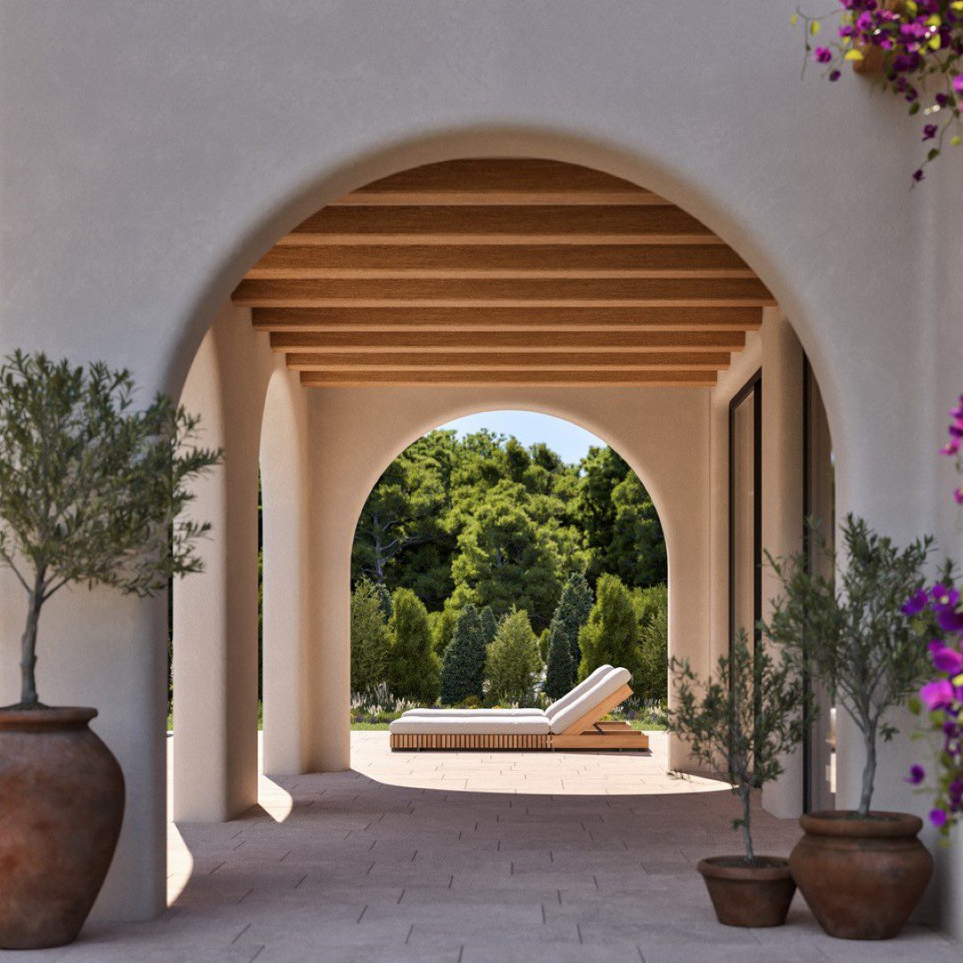 A view through an archway showcasing the garden of a 4-bedroom villa in Moraira - The Estates