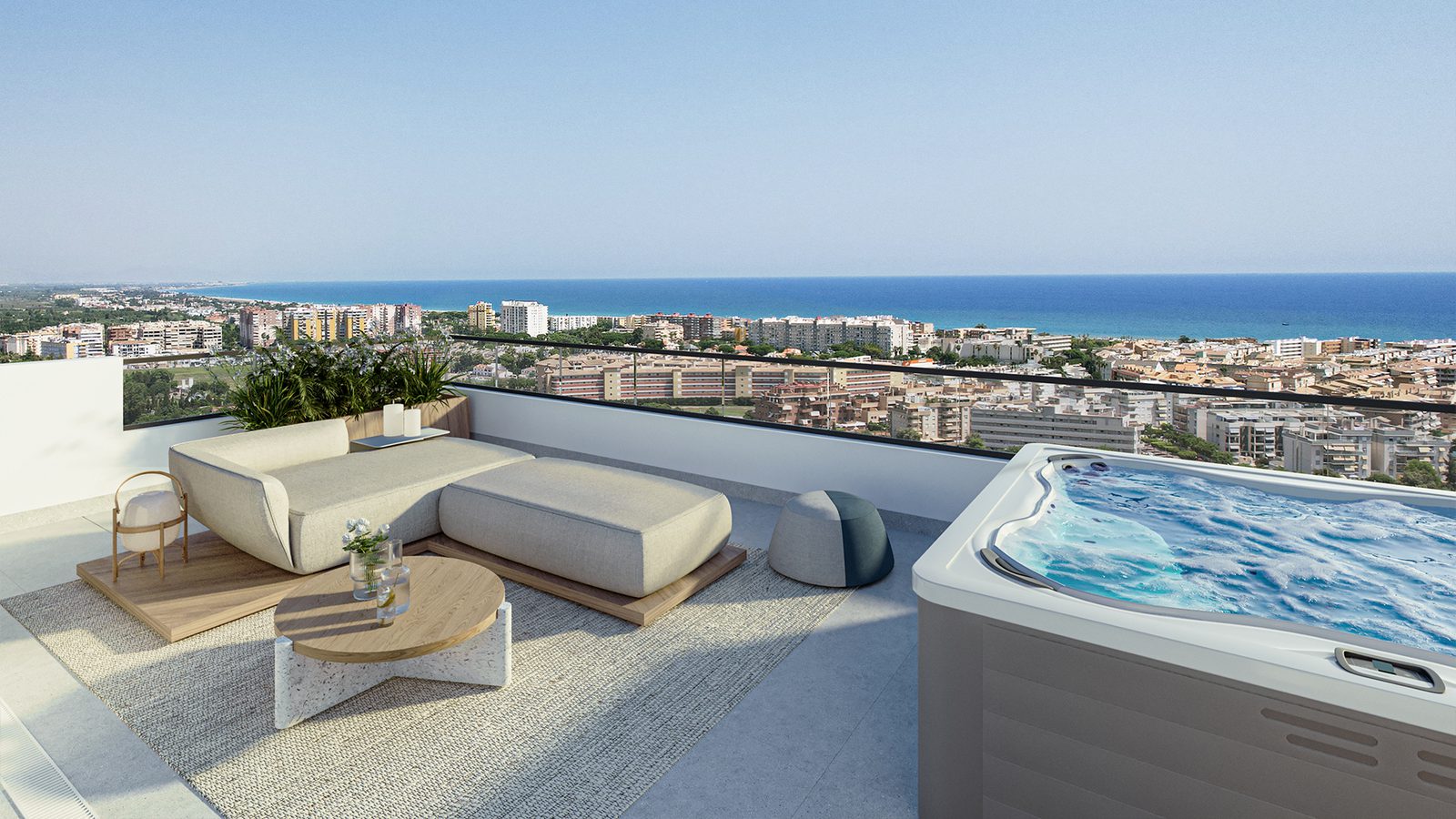 A luxurious terrace with a hot tub and seating area overlooking the coastline of a 3-bedroom apartment in Valencia - The Estates
