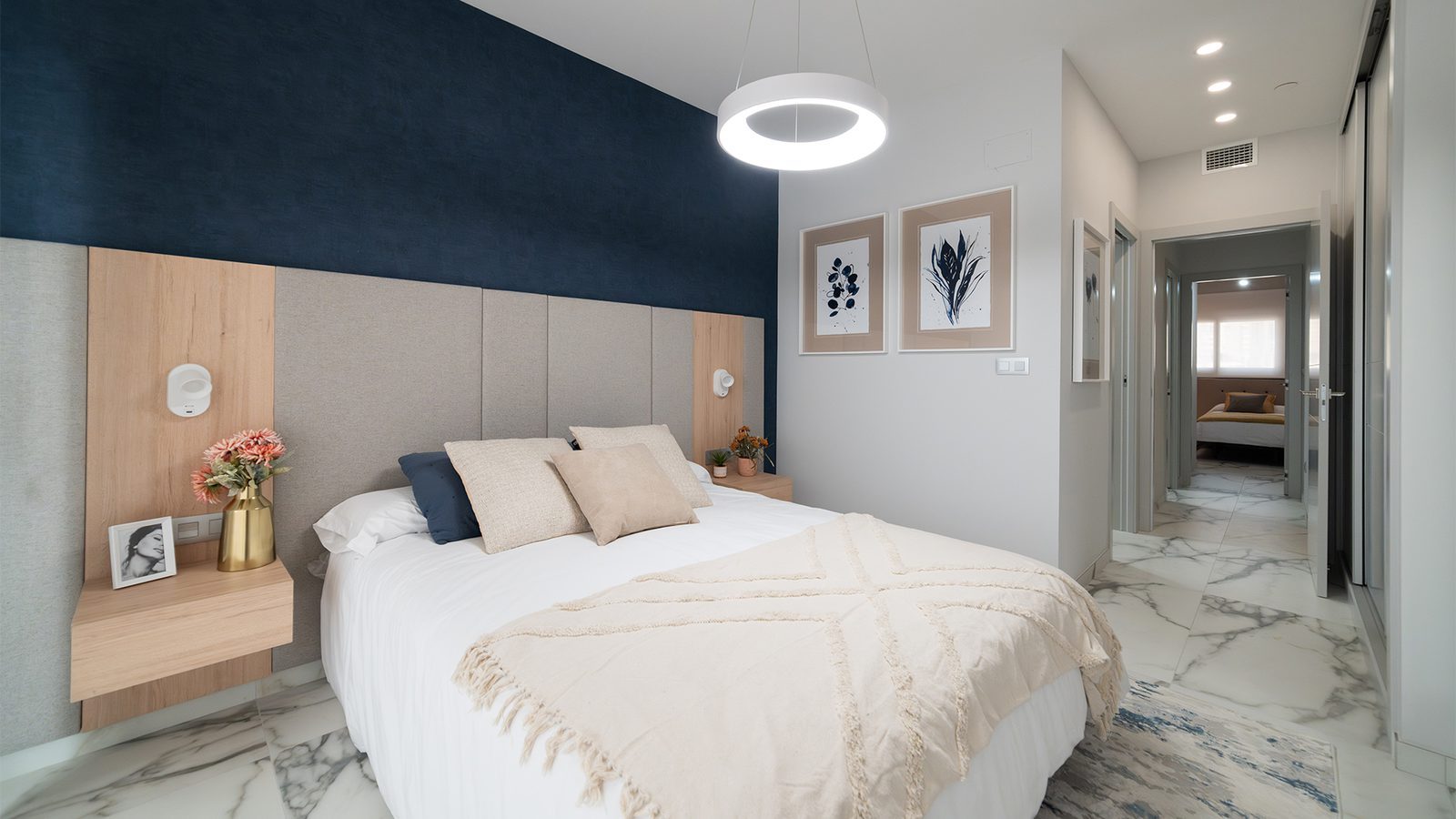 Modern bedroom with upholstered headboard, double bed, pendant light and marble-effect flooring in a 4-bedroom apartment in Benidorm - The Estates