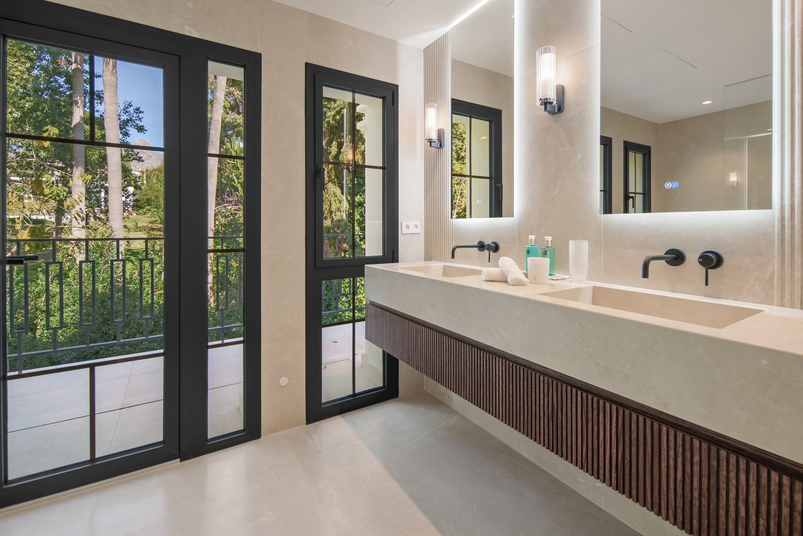 Contemporary bathroom with double vanity, black-framed windows and garden views in a 6-bedroom villa in Málaga - The Estates