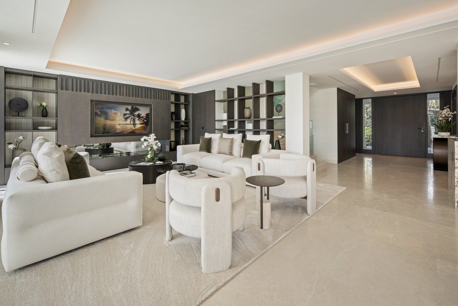 Contemporary living room with white sofas, dark shelving and wall-mounted TV in a 6-bedroom villa in Málaga - The Estates