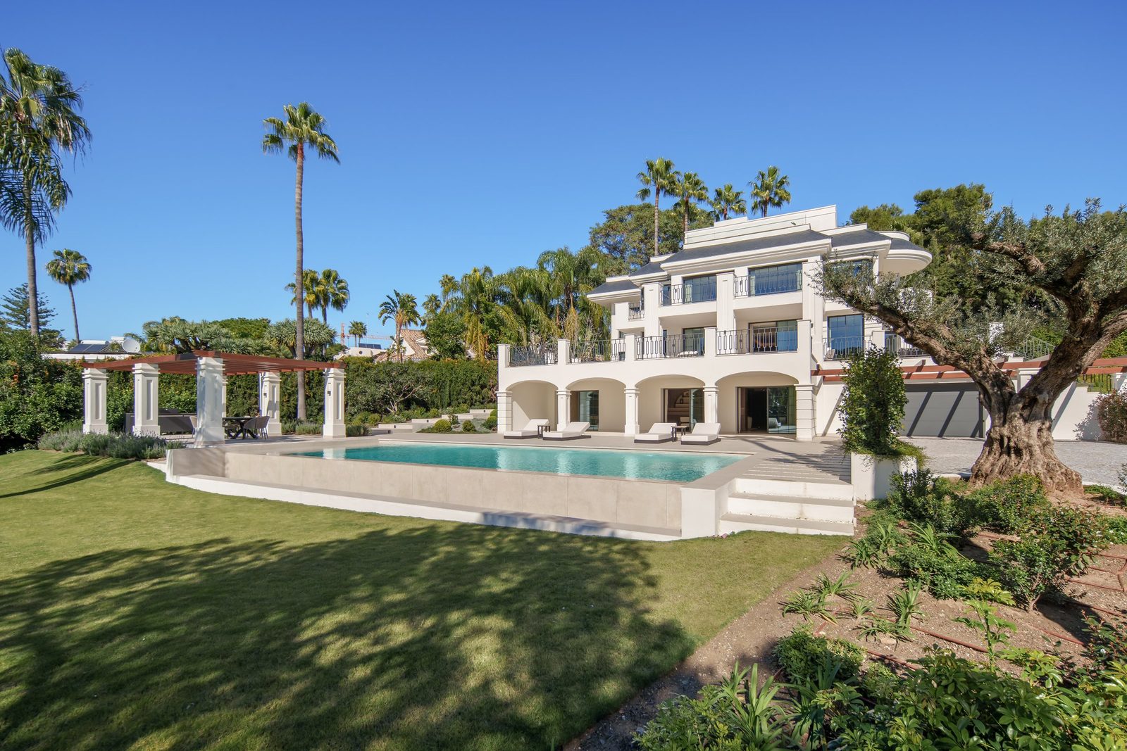 Exterior view with swimming pool and landscaped gardens of a