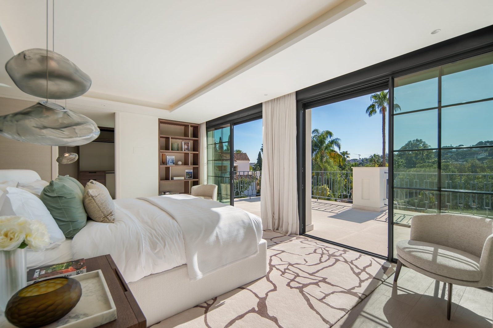 Bright bedroom with balcony, palm views and floor-to-ceiling windows in a 6-bedroom villa in Málaga - The Estates