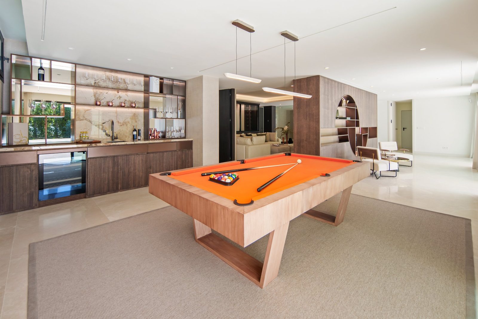 Modern games room with an orange pool table and bar of a 6-bedroom villa in