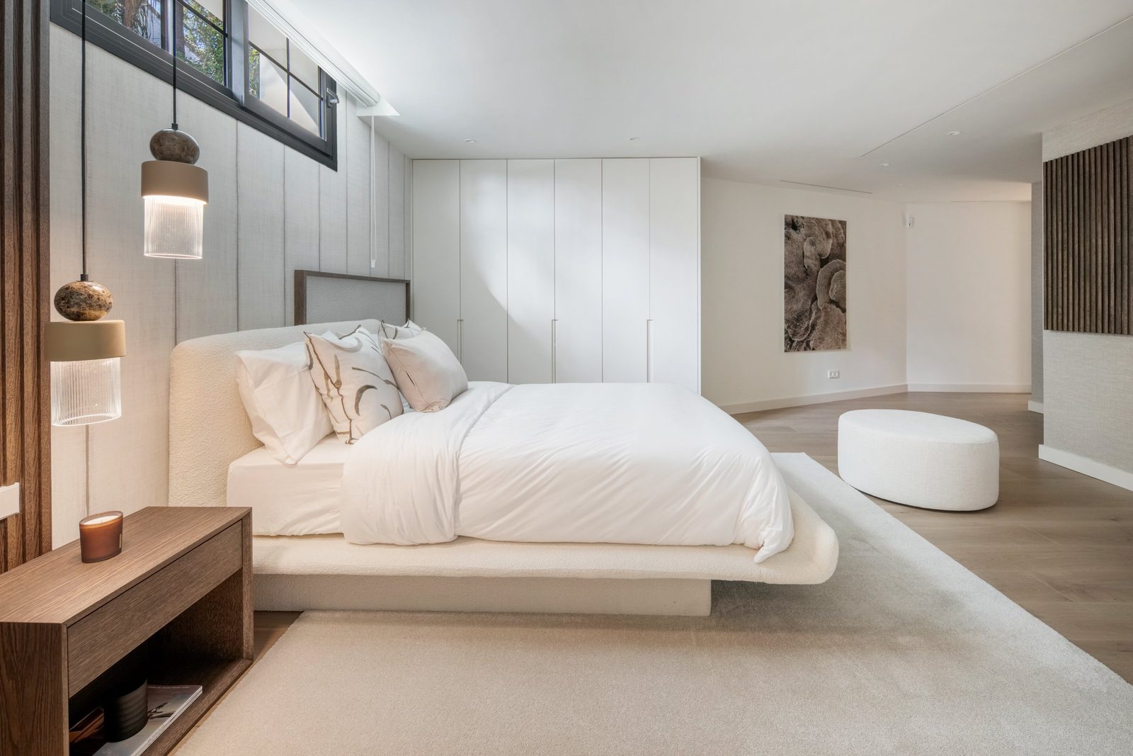 Contemporary master bedroom with upholstered bed, fitted wardrobes and pendant lighting in a 6-bedroom villa in Málaga - The Estates
