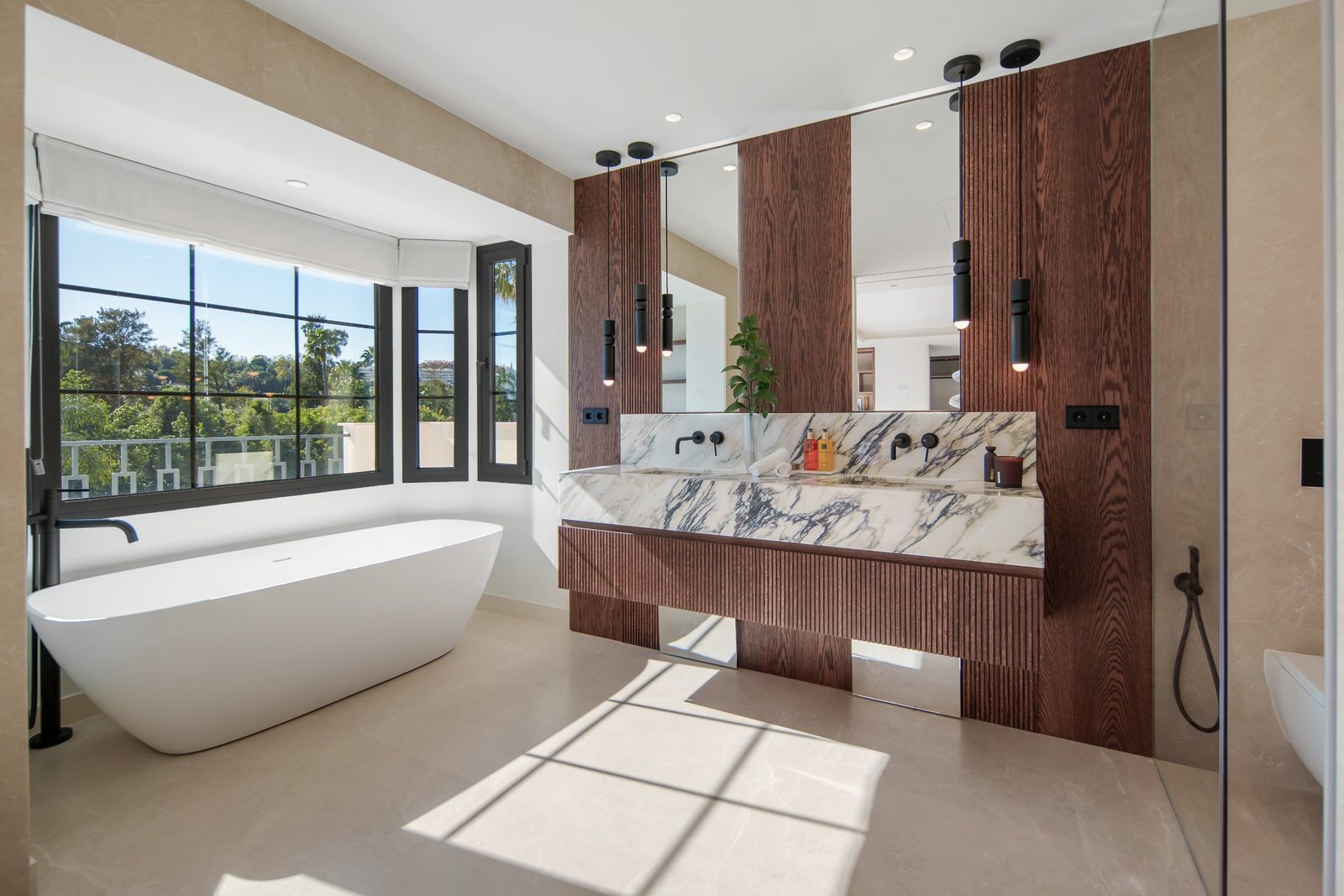Contemporary bathroom with freestanding tub, double vanity and garden views in a 6-bedroom villa in Málaga - The Estates