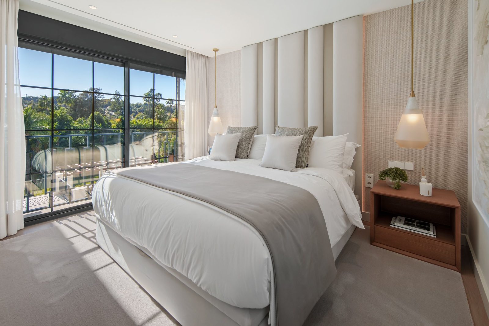 Bright modern bedroom with king-size bed and garden views of a 6-bedroom villa in Málaga - The Estates