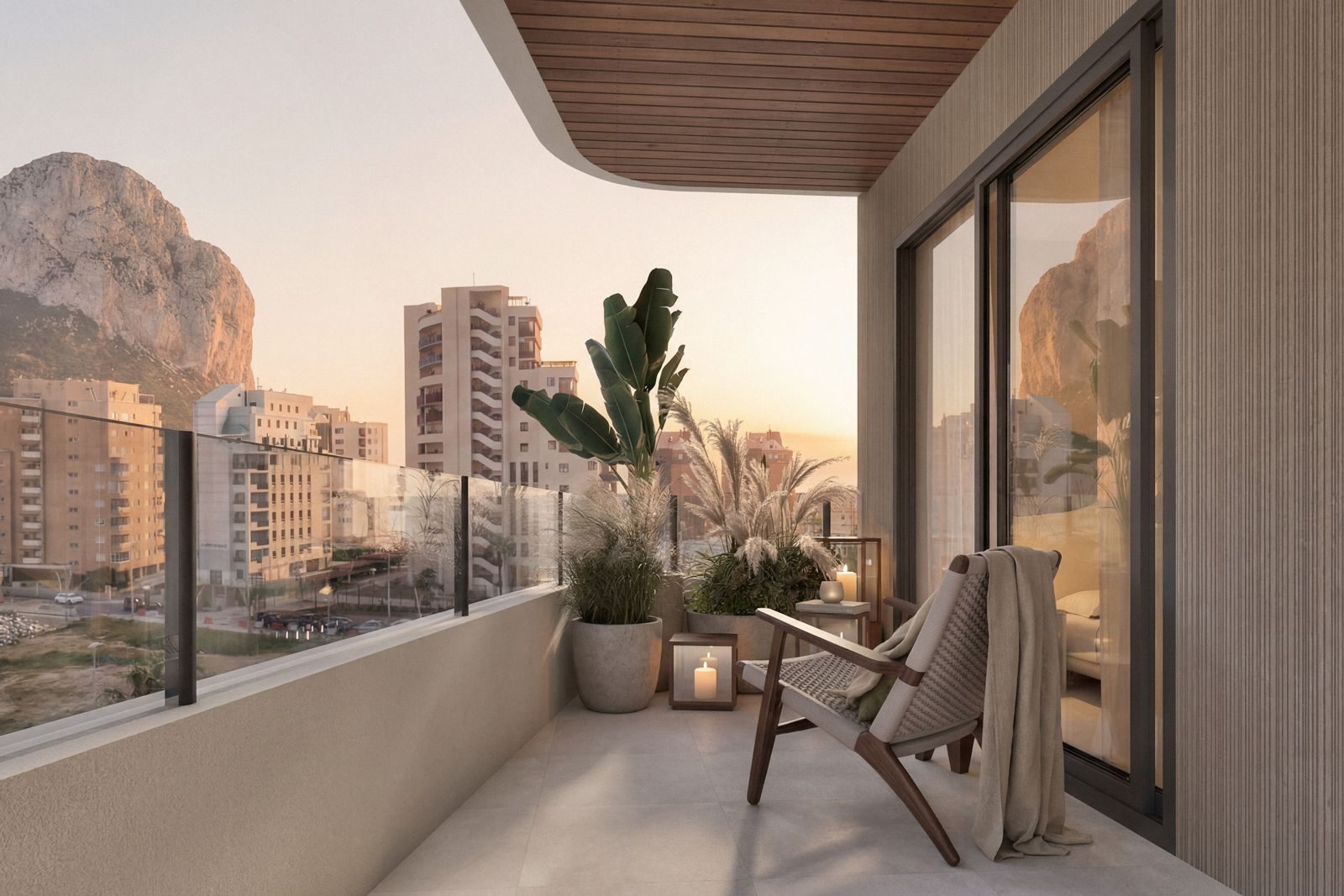 Covered terrace with lounge chairs, plants and mountain and city views of a 2-bedroom apartment in Calpe - The Estates