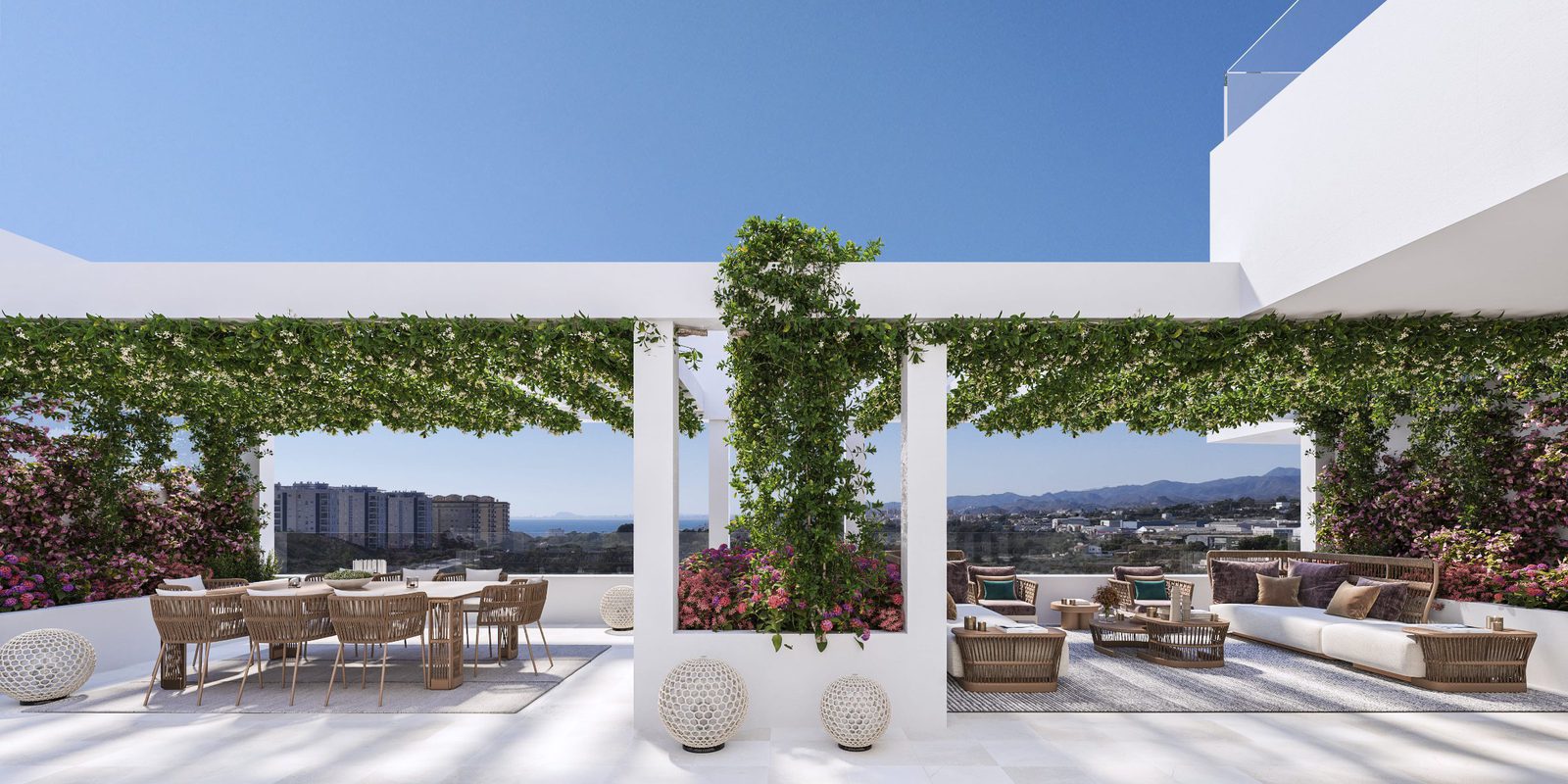 A stylish terrace with seating and greenery overlooking the sea from a 2-bedroom apartment in Villajoyosa - The Estates