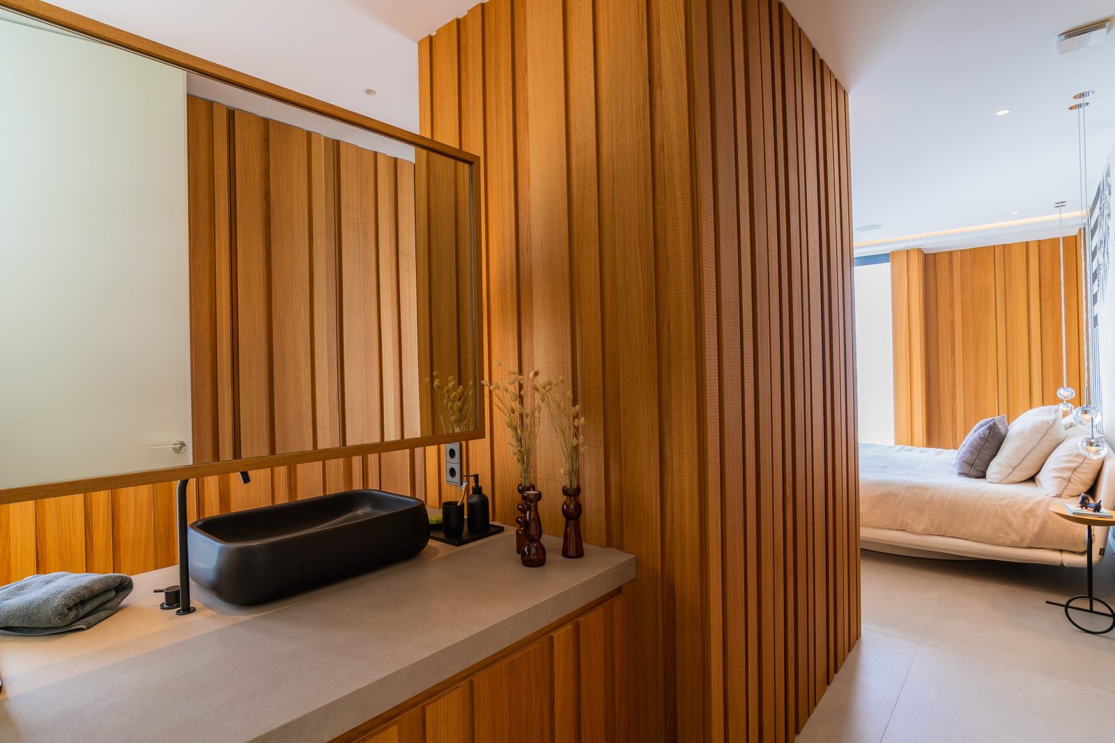 Stylish bathroom interior with wood paneling and a modern sink in a 5-bedroom villa in Benitachell - The Estates