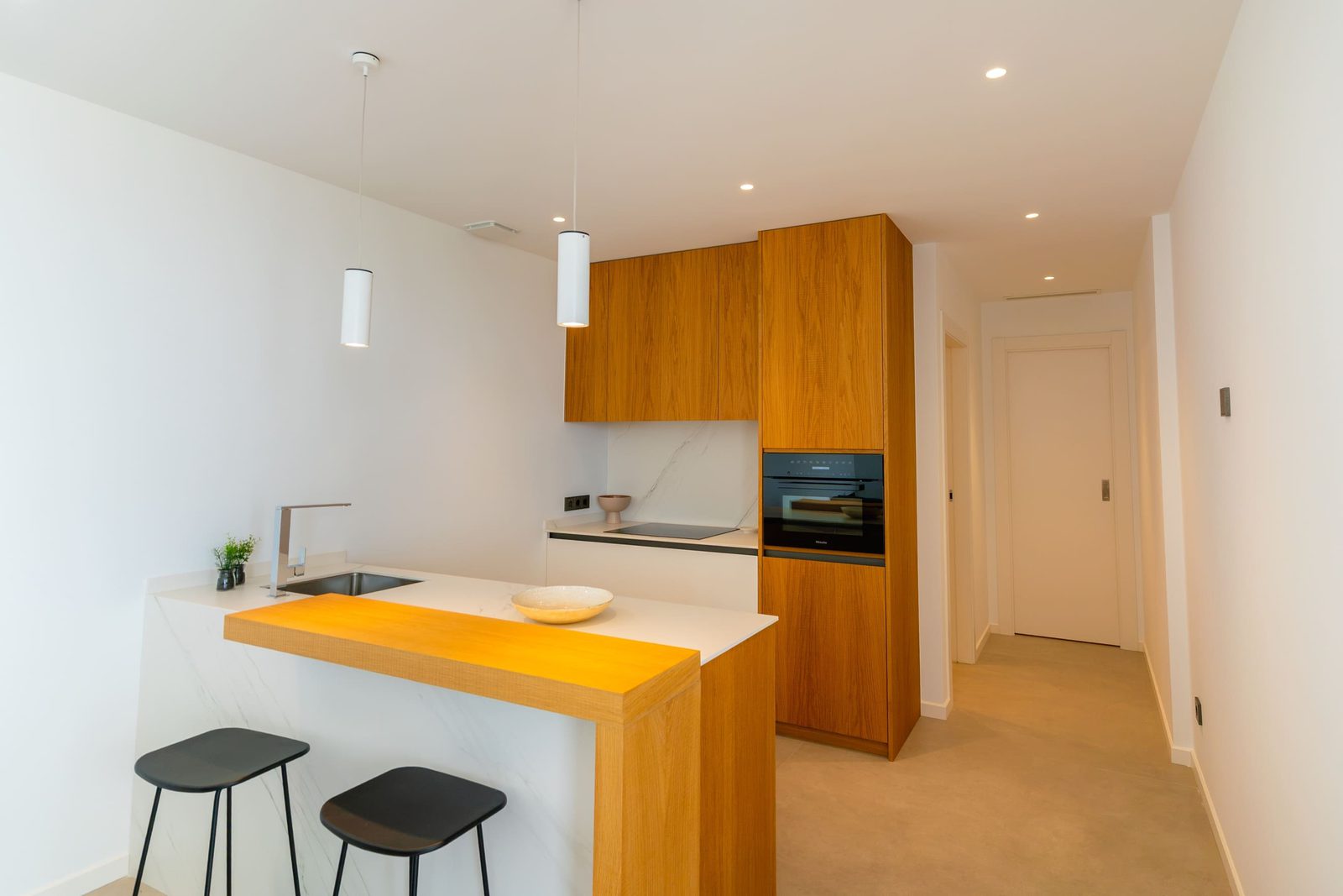 Modern kitchen with bar seating in a 5-bedroom villa in Benitachell - The Estates