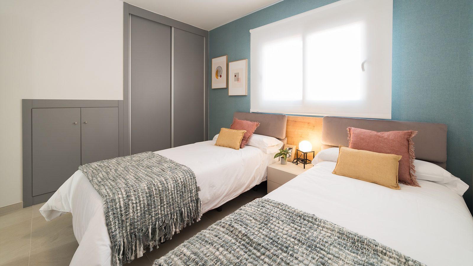 Twin bedroom with fitted wardrobes, bedside tables and colourful cushions in a 2-bedroom bungalow in Pulpí - The Estates