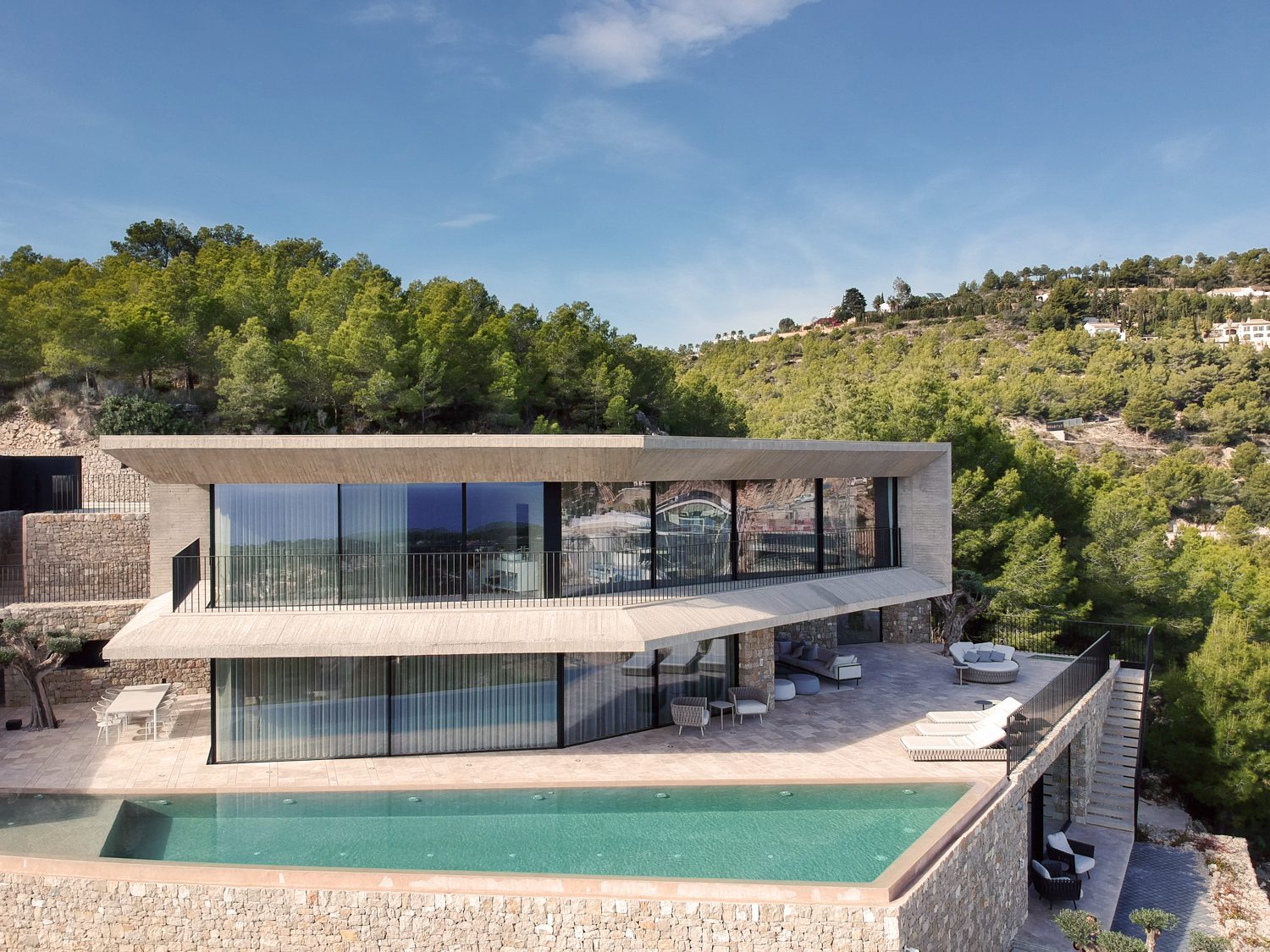 Modern villa with infinity pool, glass walls and terraces overlooking lush hills in Benissa - The Estates