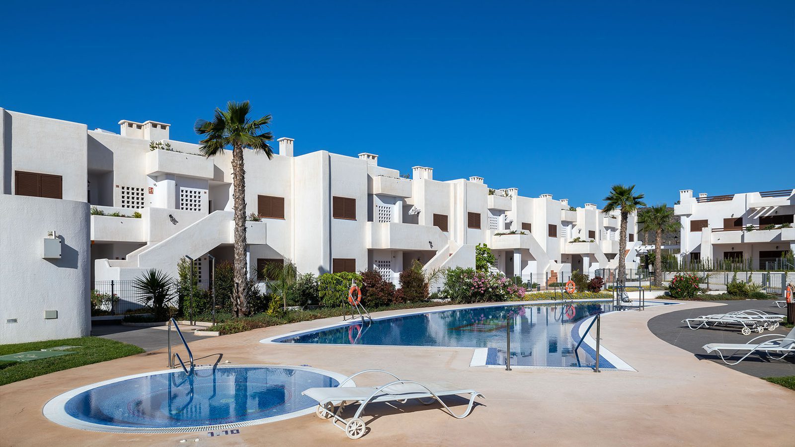 Communal swimming pool and whitewashed residences
