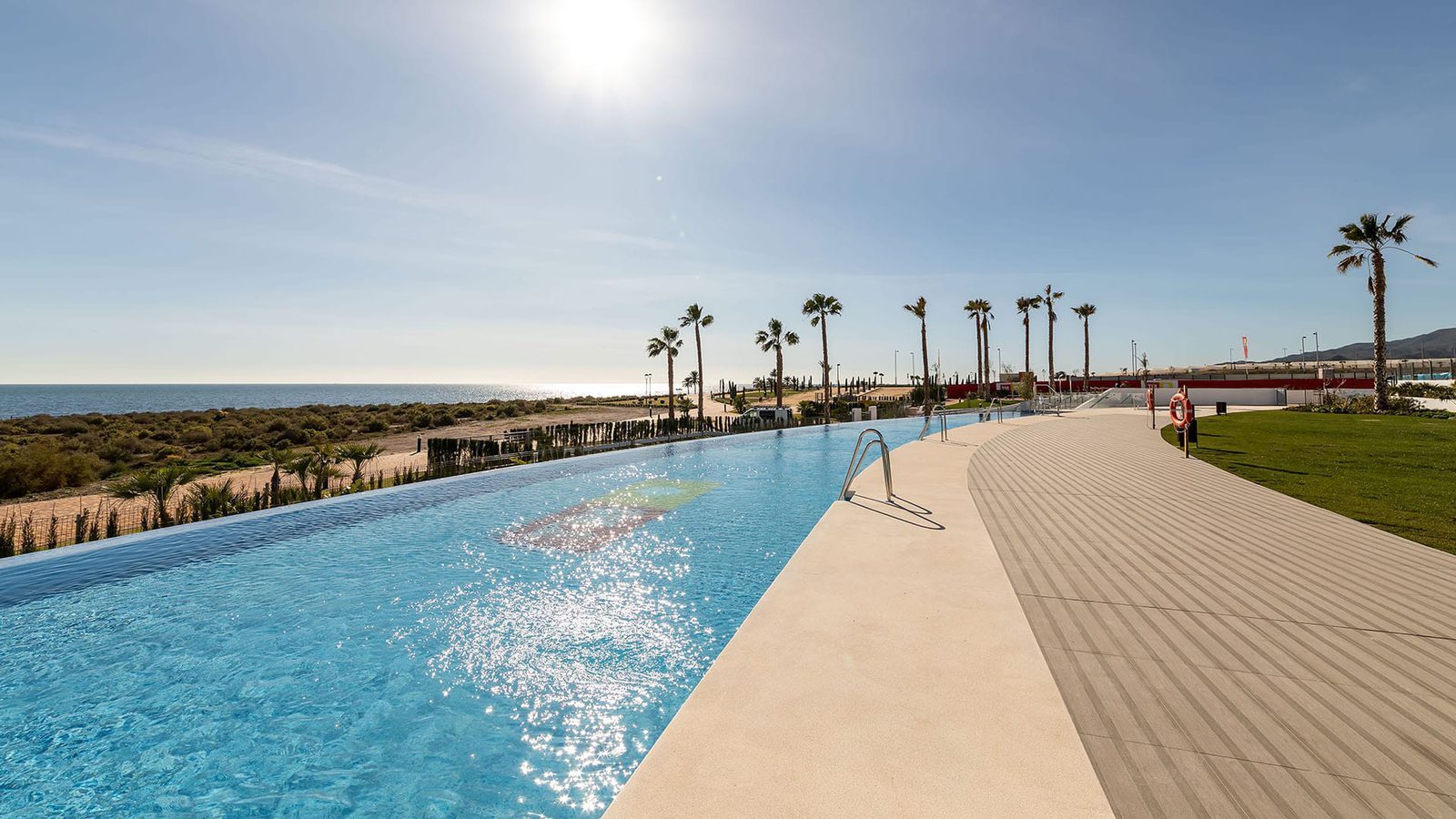 Outdoor swimming pool and sun terrace overlooking the sea at a 3-bedroom