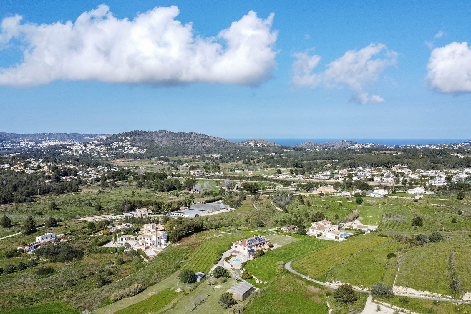 Panoramic views of the countryside, golf course, and coastline near a 3-bedroom finca in Benitachell - The Estates