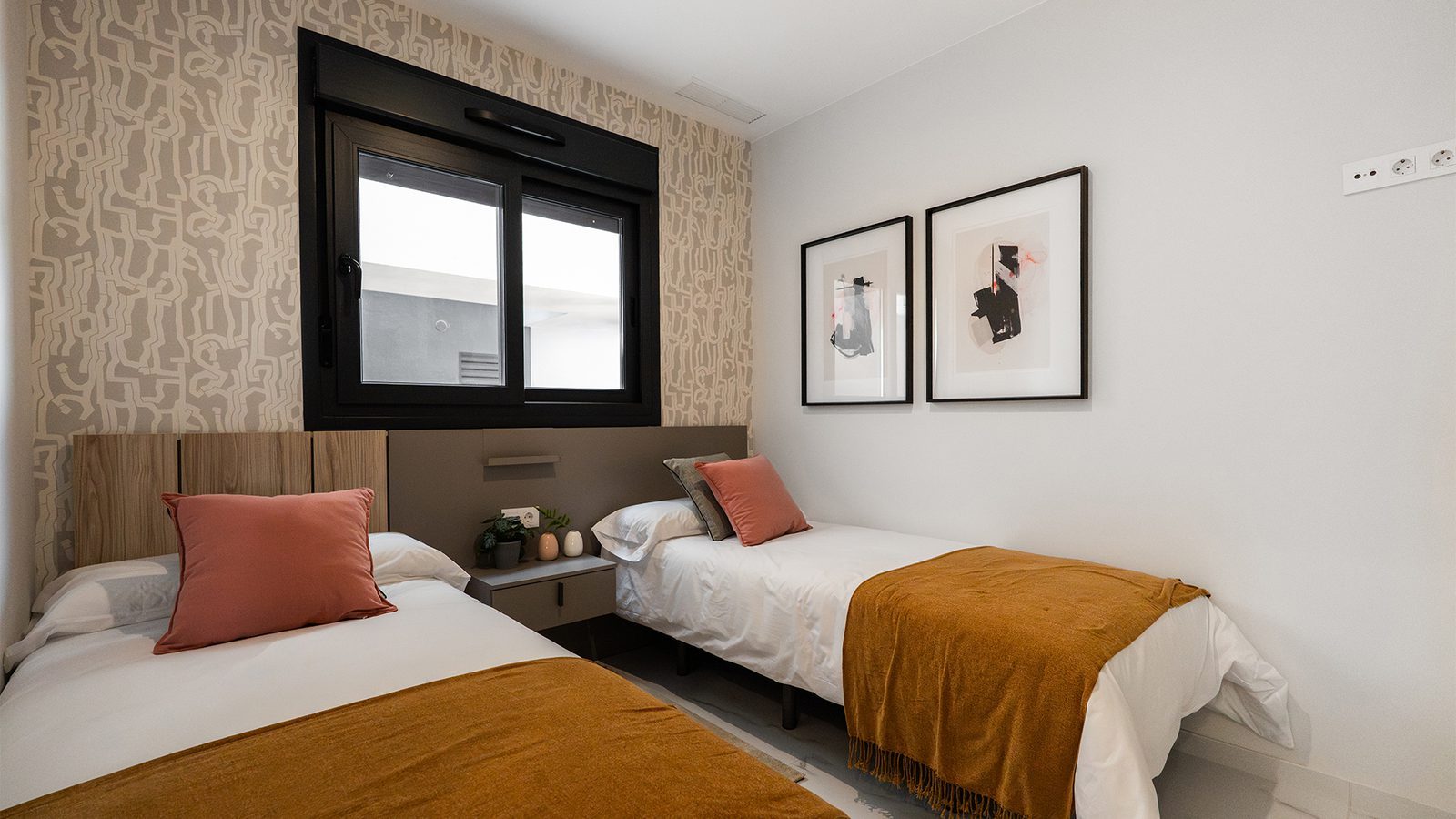Twin bedroom with patterned wallpaper, black-framed window and framed artwork in a 3-bedroom bungalow in Torrevieja - The Estates