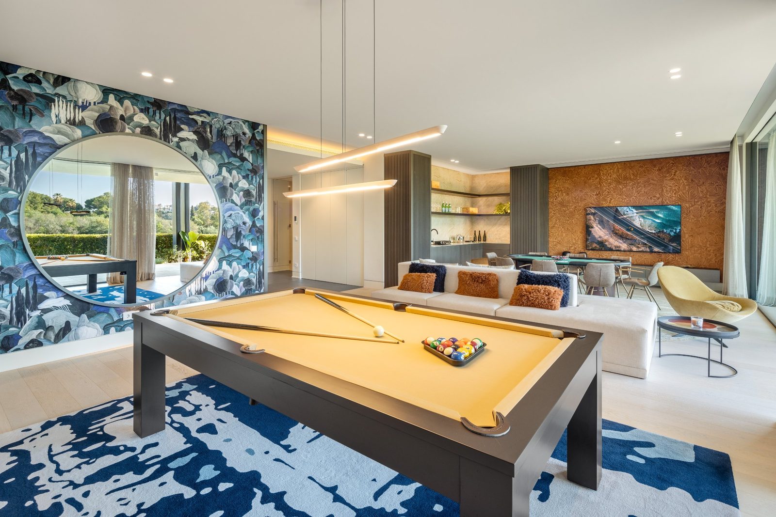 Elegant games and living room with pool table, lounge seating and dining area of a 6-bedroom villa in Málaga - The Estates