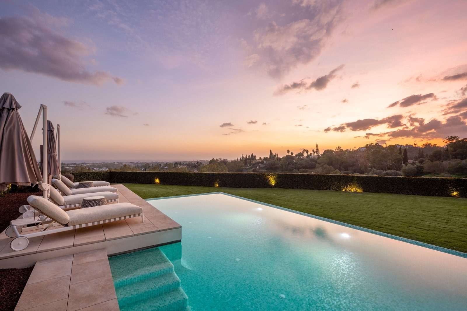 Infinity pool and loungers overlooking panoramic sea views at