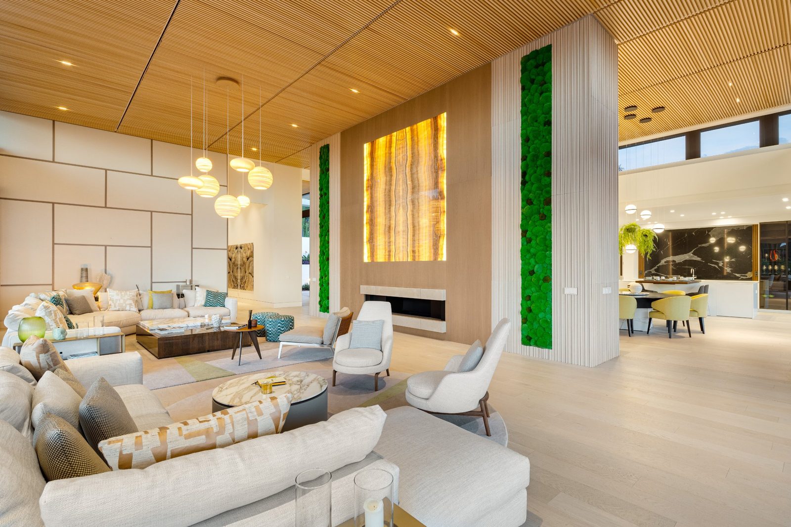 Contemporary living room with fireplace and open-plan kitchen of a