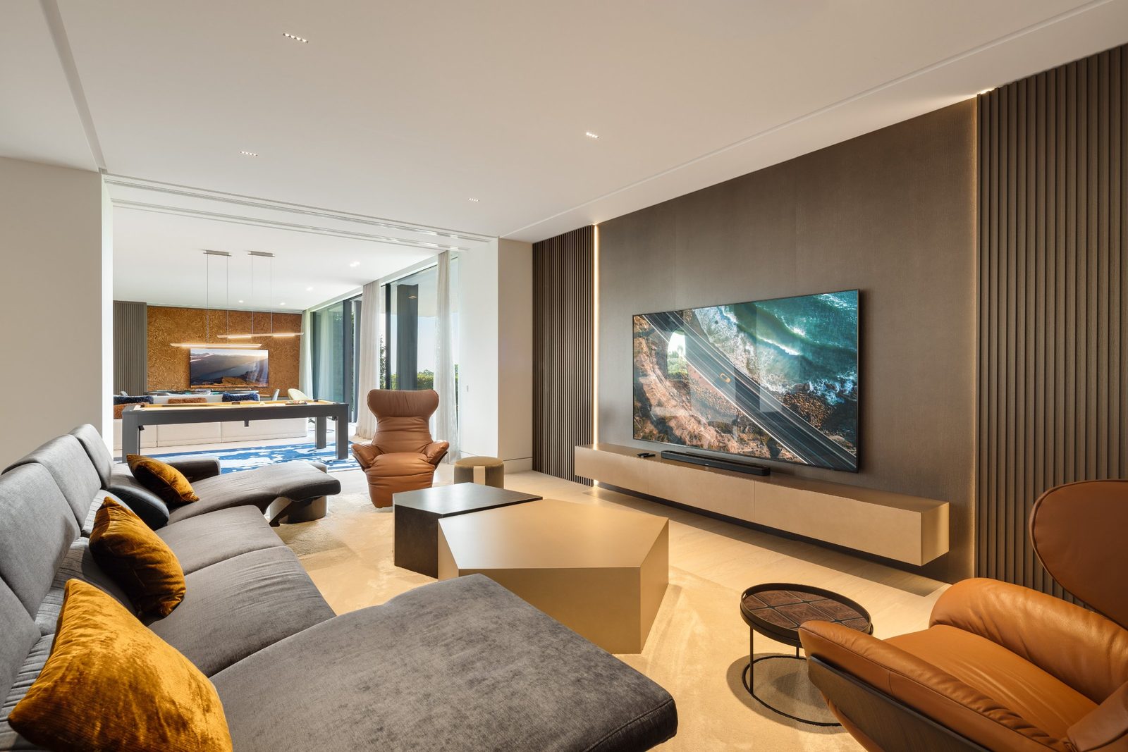 Contemporary living room with sectional sofa, TV wall and pool table of