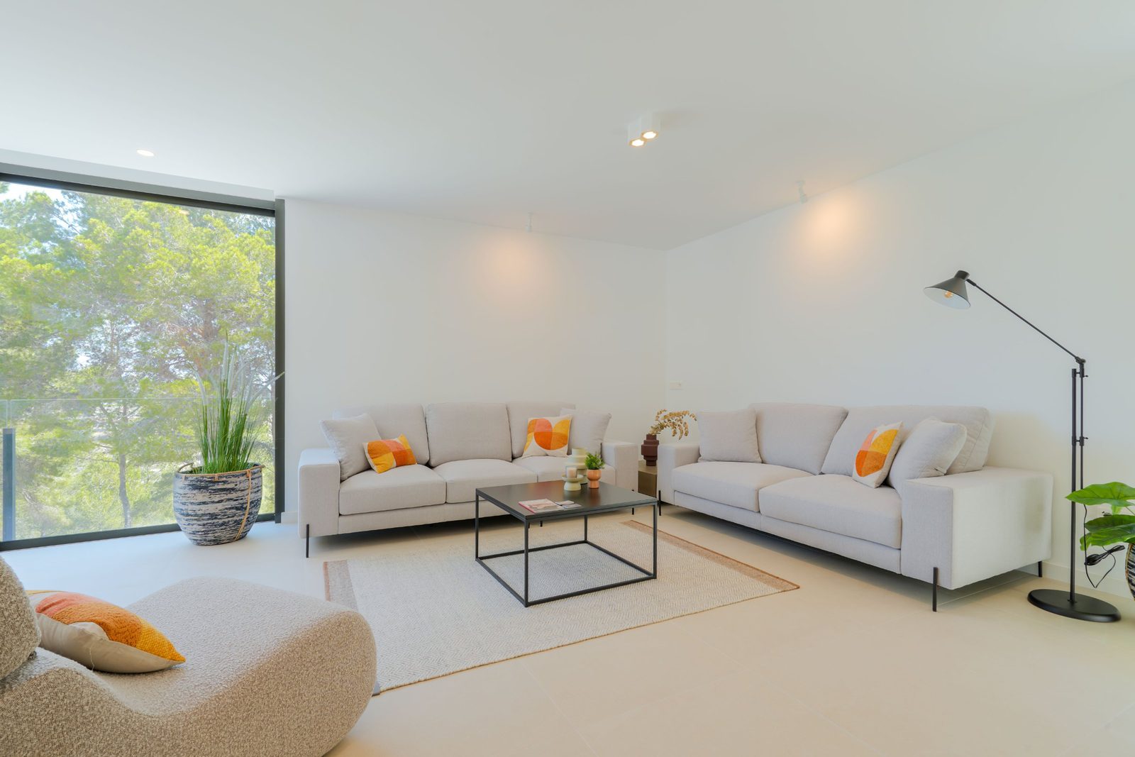 Stylish living room with large windows overlooking countryside views of a 4-bedroom villa in Moraira - The Estates