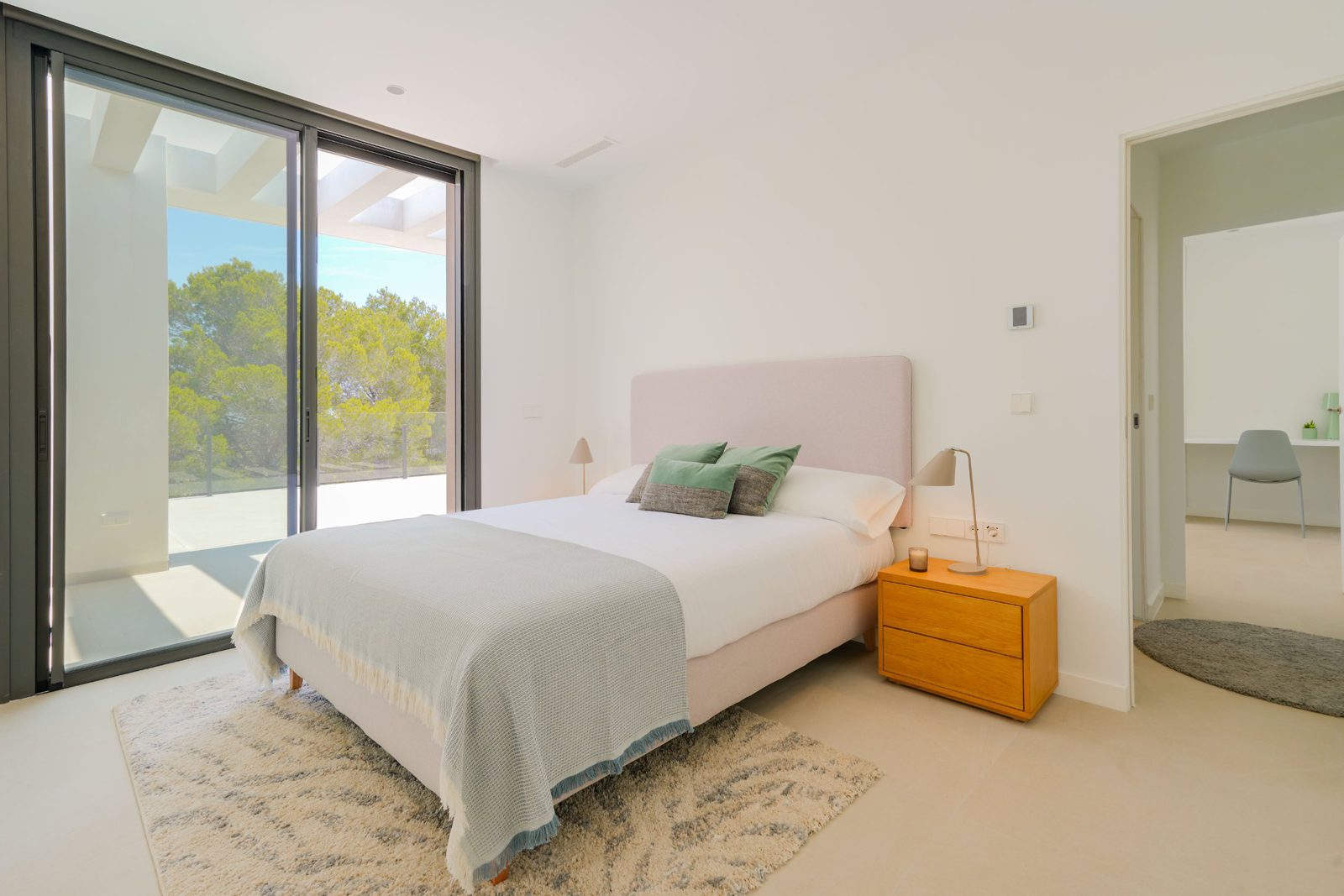 A bright bedroom with countryside views inside a 4-bedroom villa in Moraira - The Estates