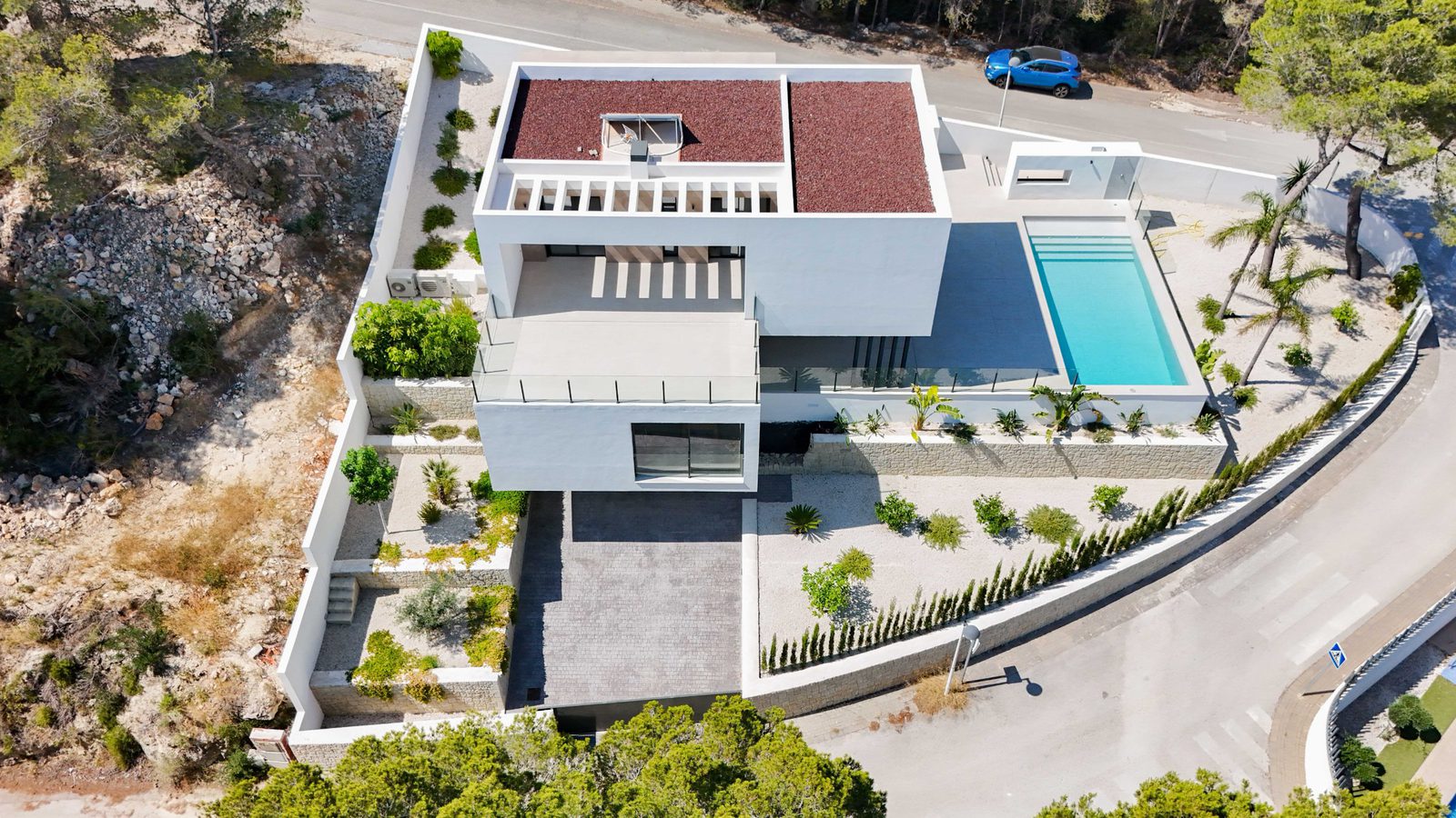 Aerial view of a modern 4-bedroom villa with a pool and surrounding countryside in Moraira - The Estates