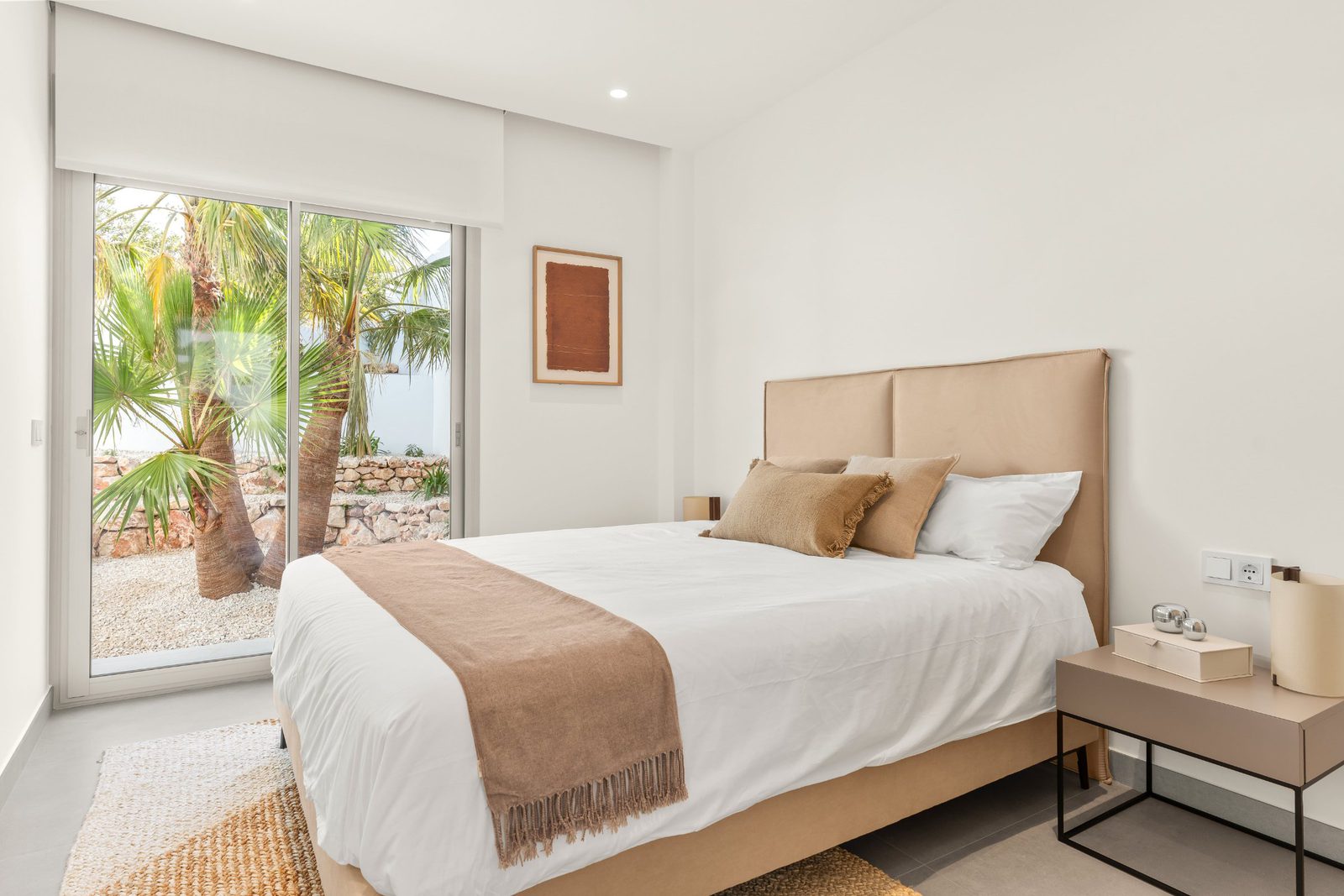 A bright bedroom with patio doors and sea views in a 3-bedroom villa in Benitachell - The Estates