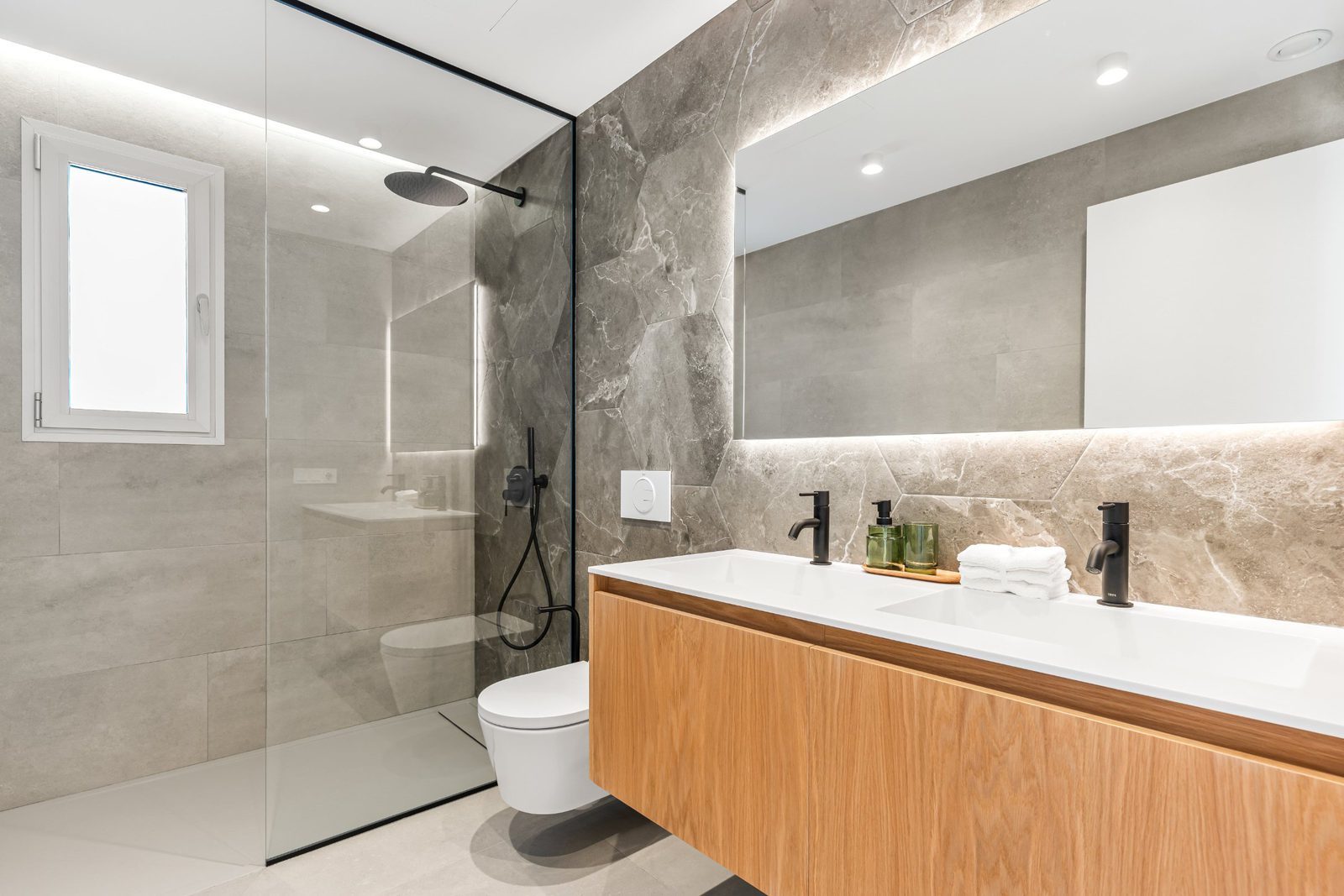A modern bathroom with a walk-in shower and double vanity in a 3-bedroom villa in Benitachell - The Estates