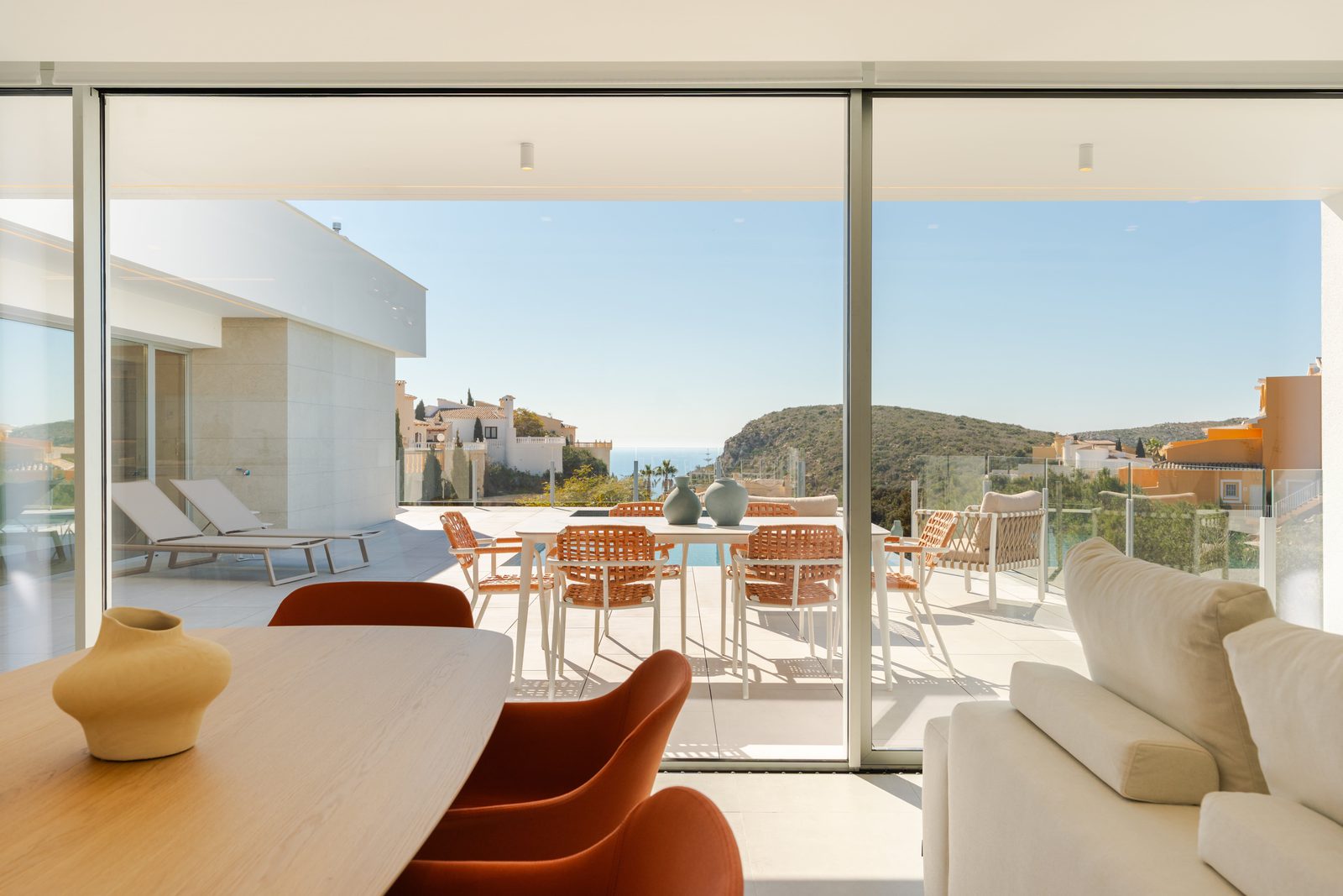 Outdoor dining and lounge area with sea views of a 3-bedroom villa in Benitachell - The Estates