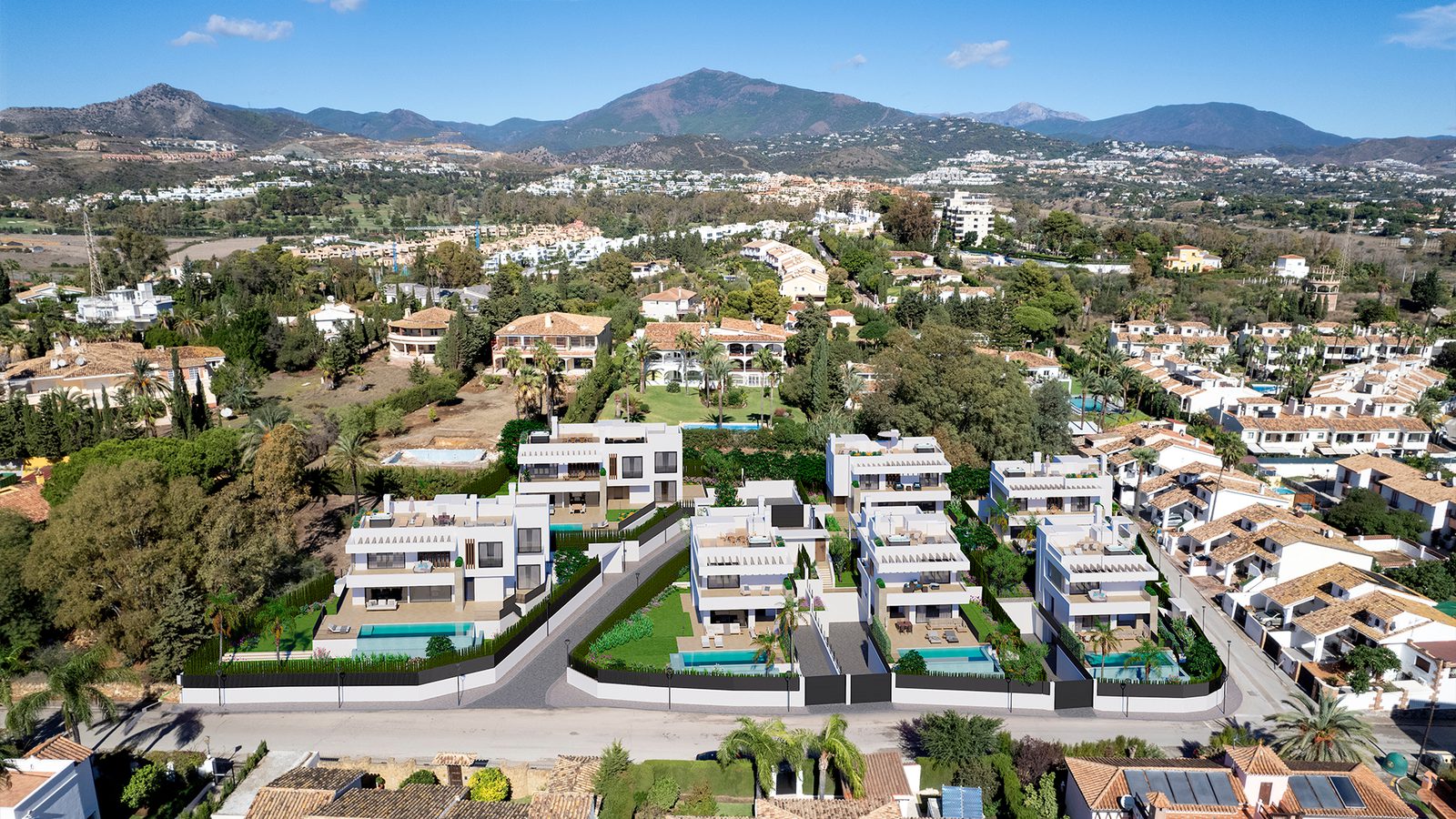 Aerial view of a luxury villa development with mountains in the background - The Estates