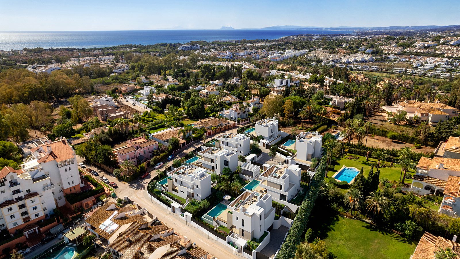 An aerial view of a luxurious 4-bedroom villa nestled in a beautiful residential area in Estepona - The Estates