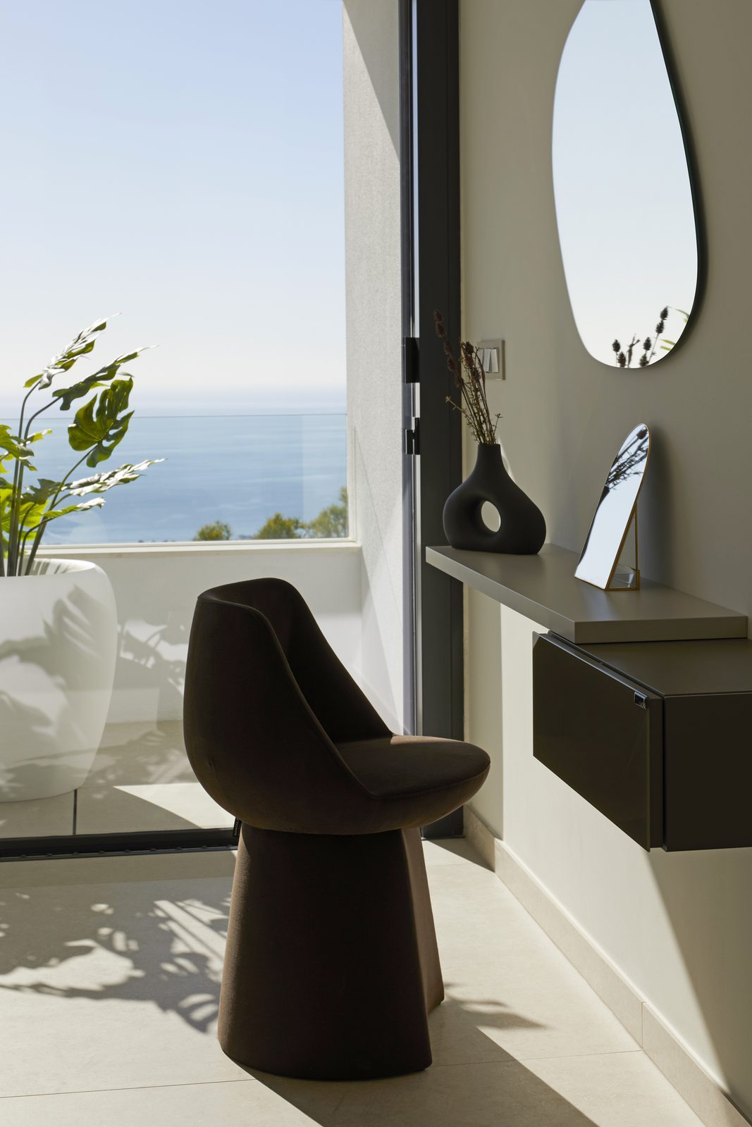 Modern interior with sea views, sculptural chair and console of a 4-bedroom villa in Altea - The Estates