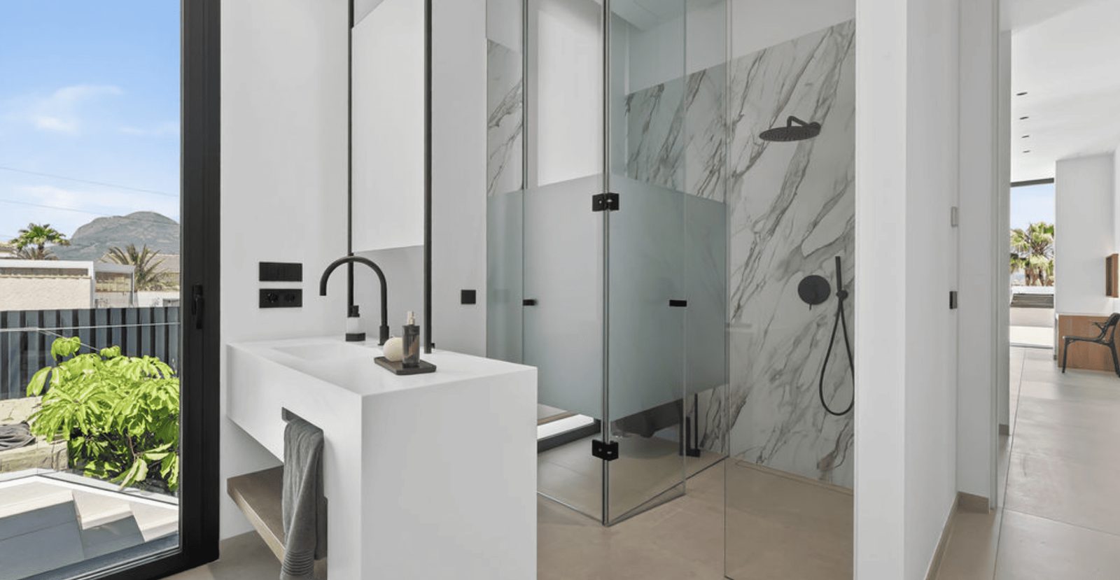 A modern bathroom with a walk-in shower in a 4-bedroom villa in La Nucia - The Estates