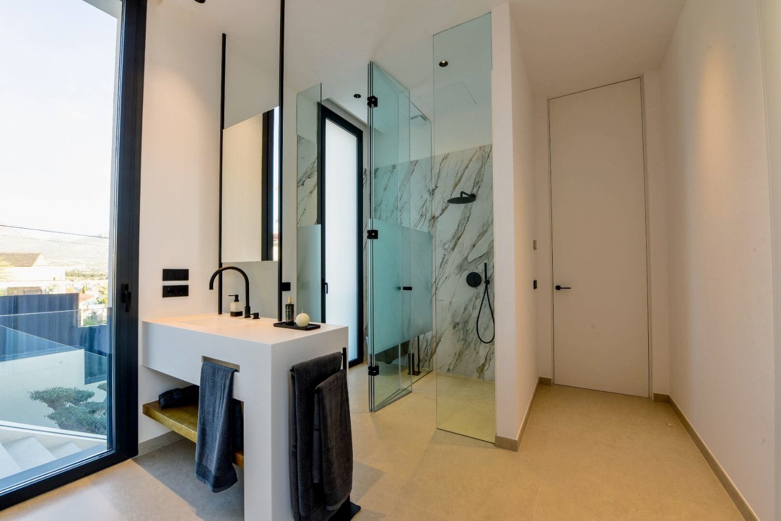 A modern bathroom with a walk-in shower and sleek fixtures in a 4-bedroom villa in La Nucia - The Estates
