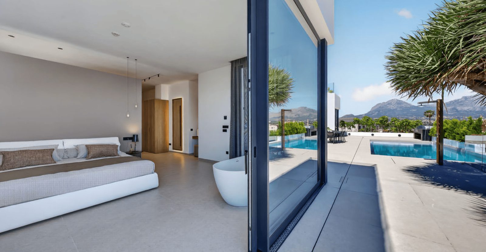 A bright bedroom with stunning sea and mountain views from a 4-bedroom villa in La Nucia - The Estates
