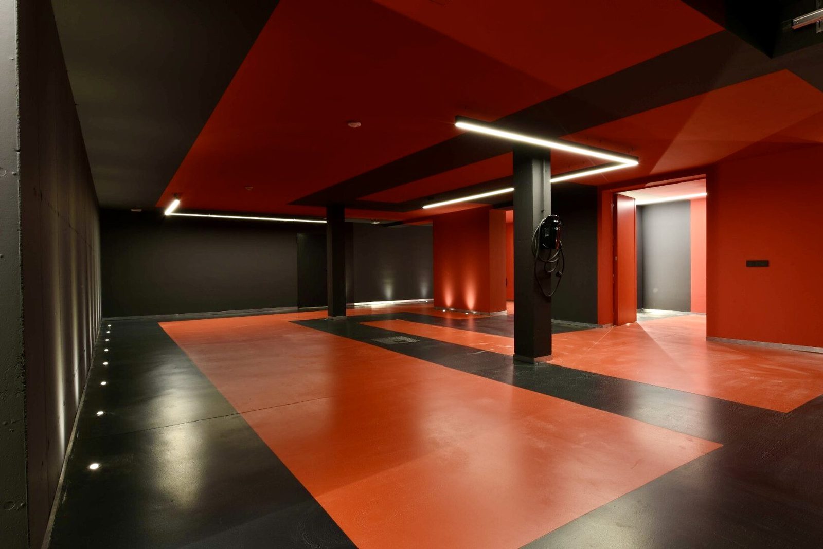Modern garage interior with red and black design elements of a 4-bedroom villa in La Nucia - The Estates