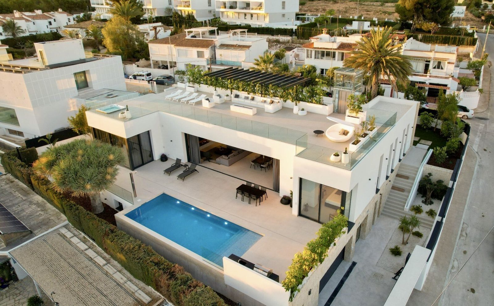 An aerial view of a modern 4-bedroom villa with a pool and rooftop terrace in La Nucia - The Estates